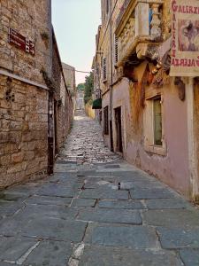 an alley with an old stone road and buildings at Old Town in Pula