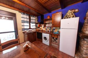 cocina con nevera y lavadora en Apartamentos La Suerte, en Hinojares