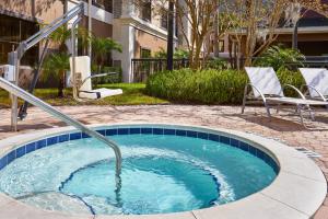 a small pool with a hose in a yard at Staybridge Suites Orlando South, an IHG Hotel in Orlando