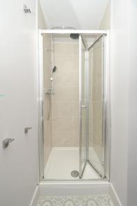 a shower with a glass door in a bathroom at Townhouse PLUS @ London Road Stoke in Stoke on Trent