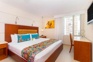 Postel nebo postele na pokoji v ubytování Hotel Dann Cartagena