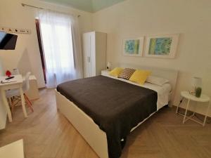 Postel nebo postele na pokoji v ubytování Le Nuvole di Ortigia