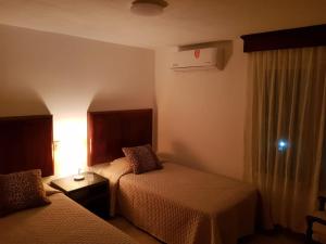 a hotel room with two beds and a window at departamento de lujo, Puerto Vallarta. Mexico in Puerto Vallarta