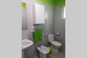 a bathroom with a white toilet and a sink at Franja de Mar - Duplex amplio y luminoso in Santa Cruz de la Palma