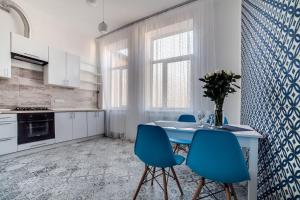 une cuisine avec une table bleue et des chaises bleues dans l'établissement Apartament on Kulisha street, à Lviv