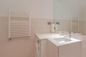 a white bathroom with a sink and a mirror at CASA CARLOTTA Tranquillità con Vista Mare in Camogli +26 photos