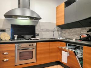 a kitchen with a stove and a sink at Casa vacanze Acero rosso in Massa Martana +43 photos