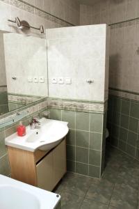 y baño con lavabo y espejo. en Apartmán TRIGA, en Snina