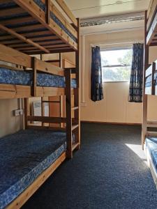a room with two bunk beds and a window at X Adventure in Horsford