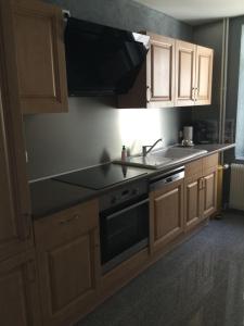 a kitchen with a sink and a stove at Appartement Wissembourg hyper centre in Wissembourg
