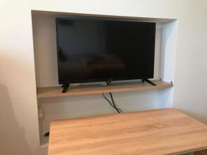 a flat screen tv sitting on a shelf at Di-Ana in Sibiu