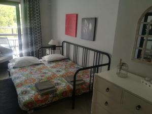 a bedroom with a bed and a dresser and a sink at Apartamento Markinca in Vilamoura