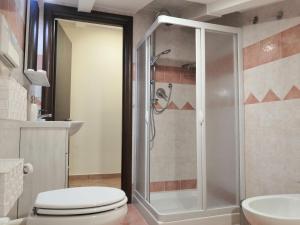 a bathroom with a shower and a toilet and a sink at Casa vacanze Acero rosso in Massa Martana