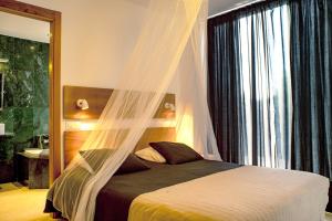 a bedroom with a bed with a mosquito net at Casa Chani with heated pool in El Roque in Cotillo