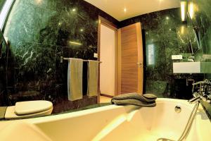 a bathroom with a toilet and a bath tub at Casa Chani with heated pool in El Roque in Cotillo +6 photos