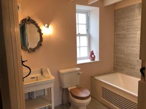 a bathroom with a toilet and a sink and a tub at Barns Bothy in Peebles