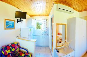 a kitchen with a white refrigerator and a window at Matina Studios in Nikiana +45 photos