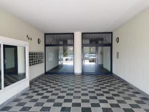 an empty room with a checkered floor at La Maison Latina Guest House in Latina