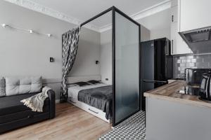 a bedroom with a bed and a mirror at City Centre Silver Apartment in Odesa