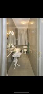 a bathroom with a sink and a toilet and a mirror at the river in Pisa