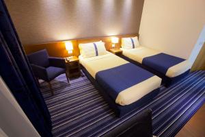 Posteľ alebo postele v izbe v ubytovaní GP Hotel