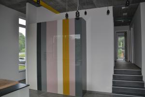 a hallway with a colorful striped wall in a house at Chez Pilar in Modave