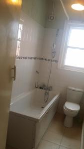 a bathroom with a bath tub and a toilet at Blackburn - Great prices, best rooms, nice place ! in Blackburn