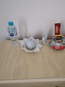 a bottle of water and a tea pot on a table at Blackburn - Great prices, best rooms, nice place ! in Blackburn