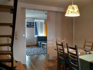 a dining room and living room with a table and chairs at Apartament na Rynku in Chęciny