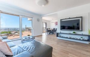 a living room with a large flat screen tv at Villas Alfa & Omega in Klis