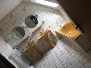 a bathroom with two sinks and a mirror at Haus Tersteegen in Oberbrombach +20 photos