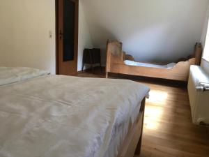 a bedroom with two beds and a wooden floor at Haus Tersteegen in Oberbrombach