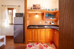 a kitchen with wooden cabinets and a stainless steel refrigerator at Casa la Viña in Puntagorda