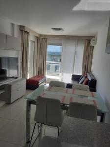 a living room with a table and a couch at Solares de Araus 203 in Colonia del Sacramento