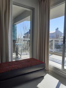 a room with a sliding glass door with a balcony at Solares de Araus 203 in Colonia del Sacramento