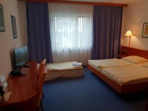 Postel nebo postele na pokoji v ubytování City Hotel Stuttgart