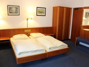 Postel nebo postele na pokoji v ubytování City Hotel Stuttgart