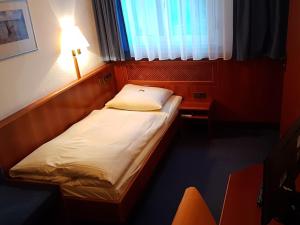 Postel nebo postele na pokoji v ubytování City Hotel Stuttgart