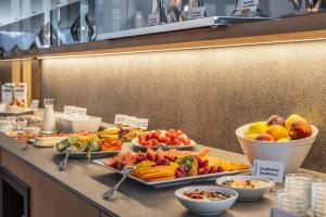 a buffet of fruits and vegetables on a counter at Maraias - Luxury Suites & Apartments in Burgusio
