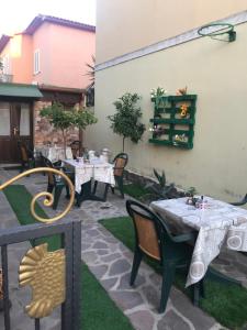 a patio with tables and chairs in a yard at Santa maria in Olbia