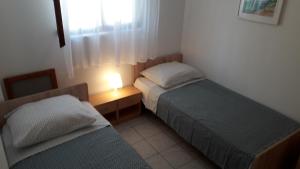 Posteľ alebo postele v izbe v ubytovaní Apartmani Mia