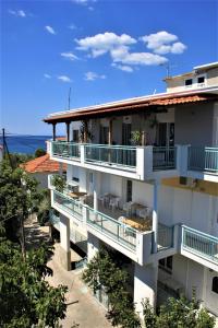 a building with balconies and the ocean in the background at House Fedra in Potos