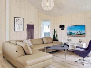 a living room with a couch and a table at Holiday home Kappeln XI in Kappeln