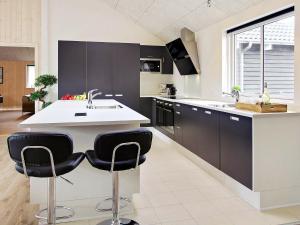 a kitchen with black and white cabinets and a sink at Holiday home Kappeln XI in Kappeln