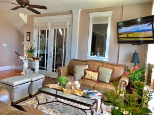 a living room with a couch and a flat screen tv at Eagle Rock Bed and Breakfast in Chemainus