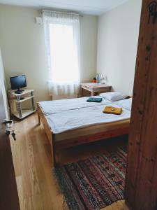 a bedroom with a bed and a window at Maria Rooms in Kuressaare