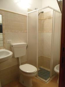 a bathroom with a toilet and a shower at trivanio semplice in Sassari