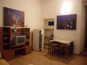 a living room with a table and a refrigerator at trivanio semplice in Sassari