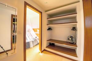 a walk in closet with a mirror and a fan at Casa Yuna with heated pool in El Roque in Cotillo