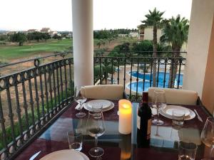 una mesa con copas de vino y una vela en el balcón en Apartamento con encanto en Campo de Golf, en Sant Jordi (San Jorge)